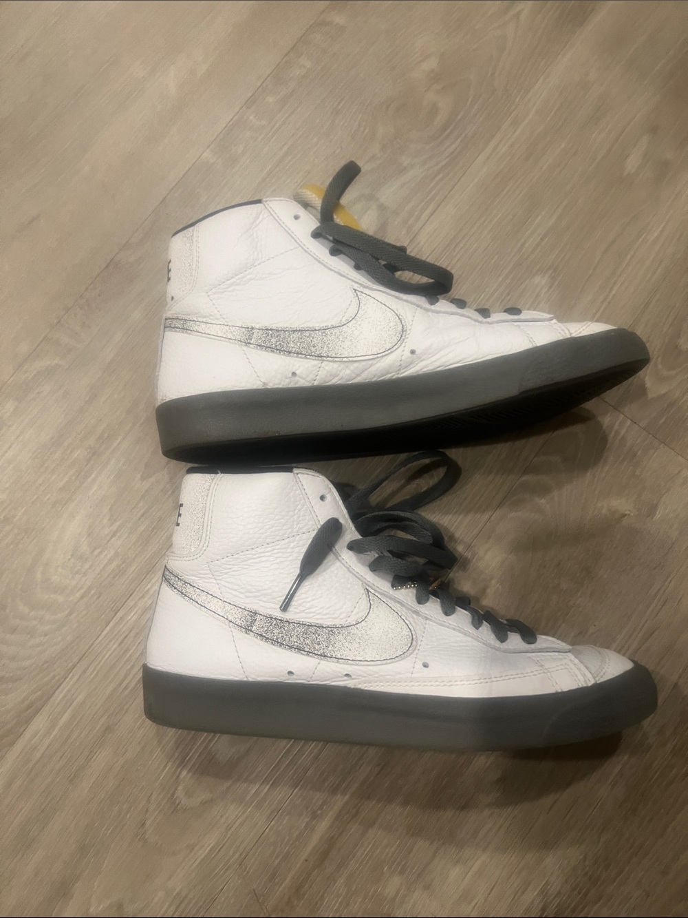 Nike Men’s White High-Top Sneakers with Black Soles and Silver Swoosh